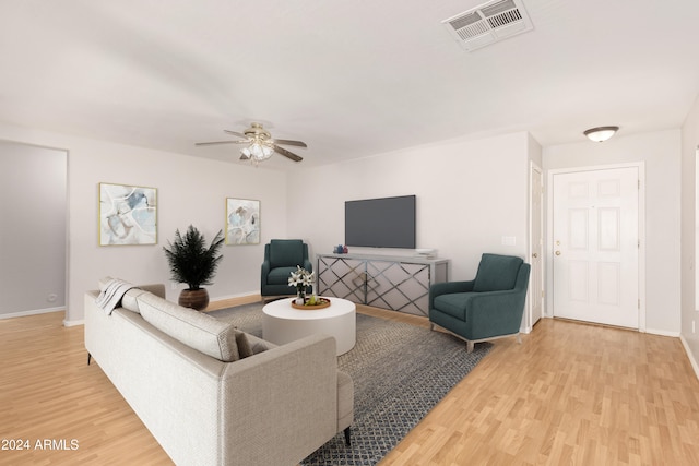 living room featuring wood-type flooring and ceiling fan