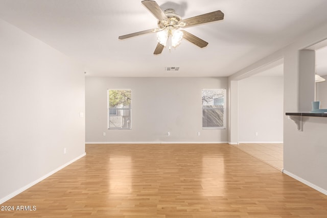 unfurnished living room with light hardwood / wood-style flooring and ceiling fan