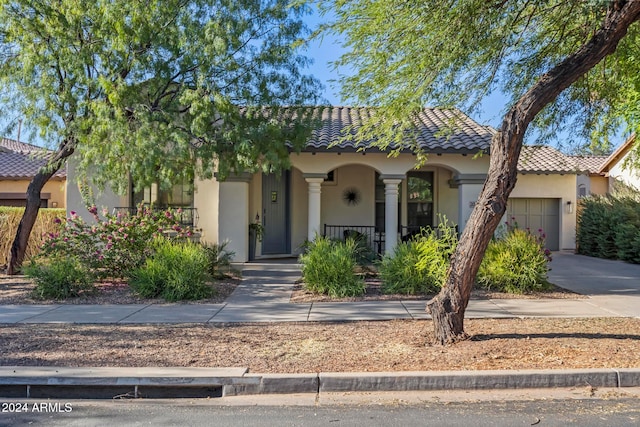 view of front of property featuring covered porch and a garage