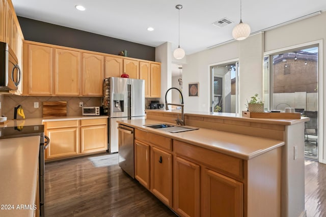 kitchen with stainless steel appliances, sink, dark hardwood / wood-style floors, hanging light fixtures, and an island with sink