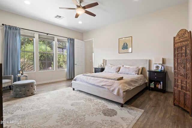 bedroom with dark hardwood / wood-style floors and ceiling fan