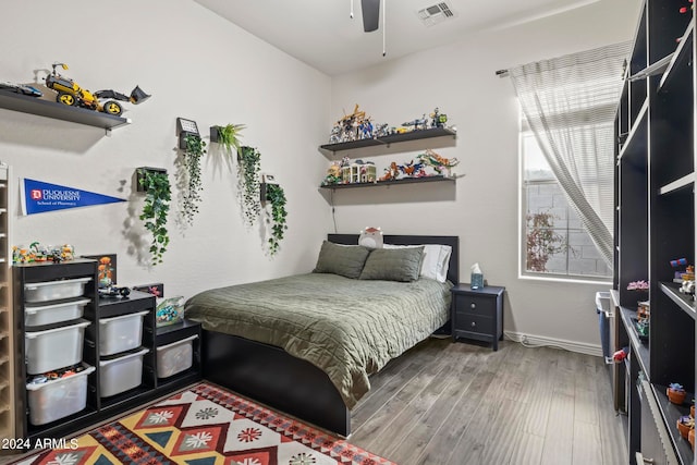 bedroom featuring hardwood / wood-style flooring and ceiling fan