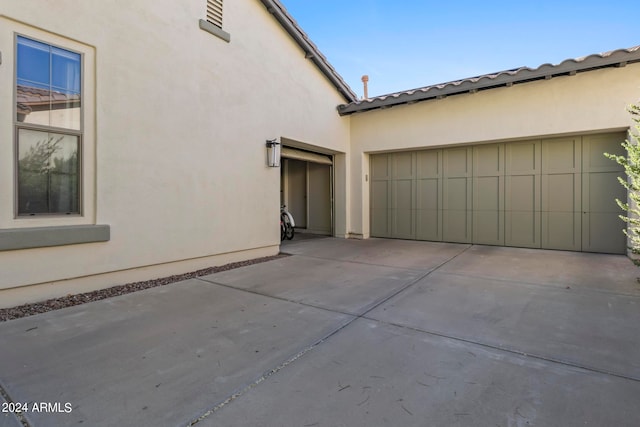 view of side of home with a garage