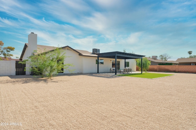 rear view of house with central AC unit and a patio area