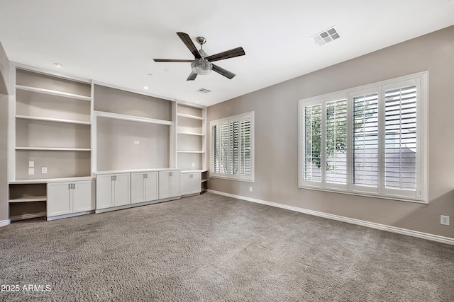 unfurnished living room featuring carpet flooring, baseboards, visible vents, and ceiling fan