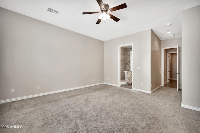 carpeted spare room with visible vents, baseboards, and ceiling fan