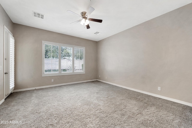 empty room featuring visible vents, baseboards, and a ceiling fan