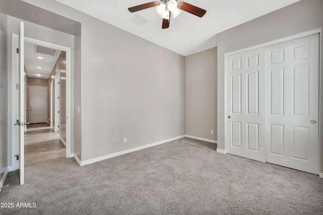 unfurnished bedroom featuring visible vents, baseboards, a closet, and carpet flooring