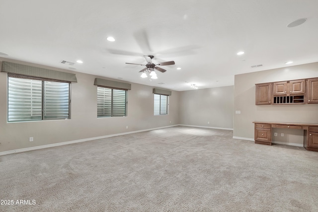 unfurnished living room featuring recessed lighting, a ceiling fan, visible vents, and light carpet