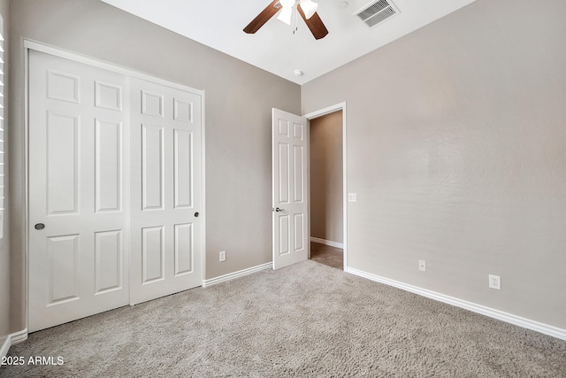 unfurnished bedroom featuring visible vents, baseboards, a closet, and carpet flooring