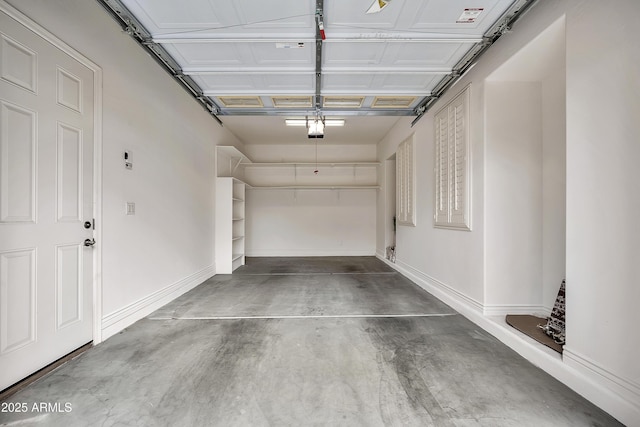 garage with baseboards and a garage door opener