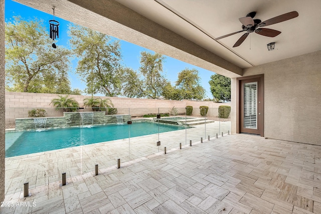 view of pool with a patio area, a pool with connected hot tub, a ceiling fan, and a fenced backyard