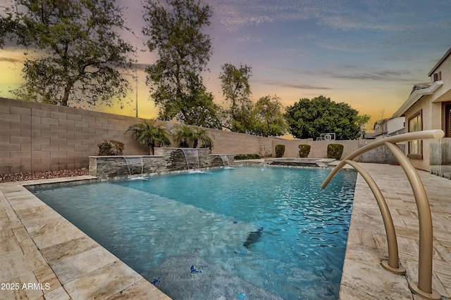 pool at dusk featuring a fenced in pool and a fenced backyard