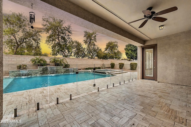 view of swimming pool with a ceiling fan, a fenced backyard, a fenced in pool, an in ground hot tub, and a patio area