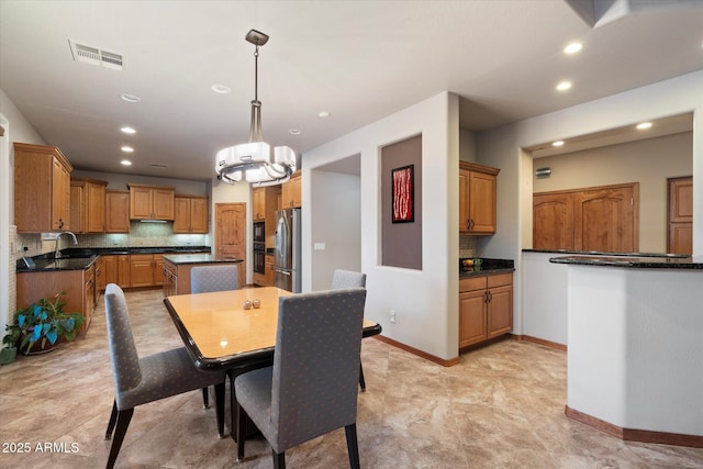 dining room featuring baseboards, visible vents, and recessed lighting