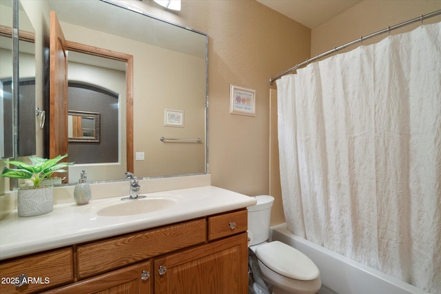 bathroom with toilet, shower / tub combo with curtain, and vanity
