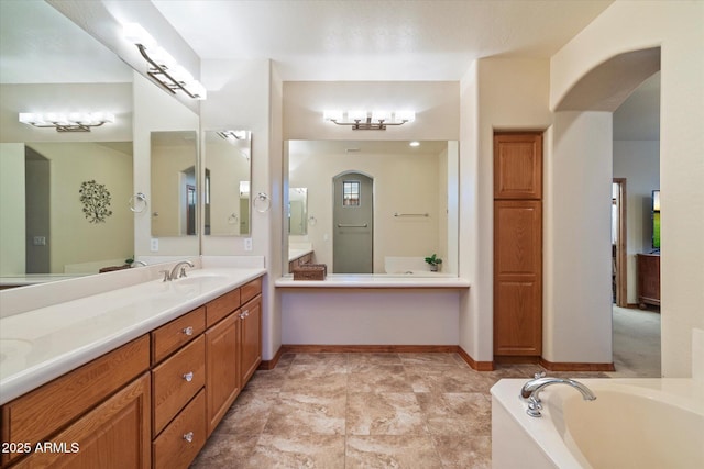 full bath featuring a bath, baseboards, and vanity