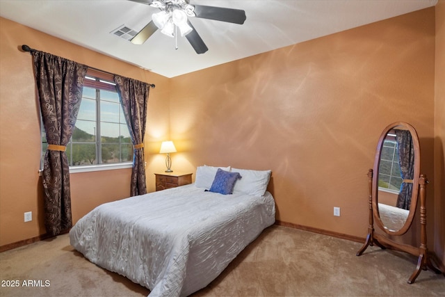 carpeted bedroom with baseboards, visible vents, and a ceiling fan