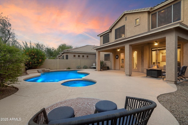 view of pool with a fenced in pool, a patio, an in ground hot tub, a fire pit, and a fenced backyard