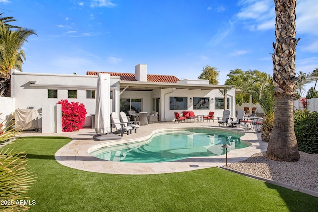 back of house with a lawn and a patio