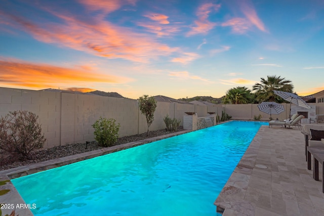 11934 S 181st Ave, Goodyear, AZ 85338 - pool at dusk featuring a patio area, a fenced backyard, and a fenced in pool