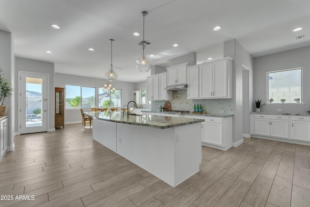 11934 S 181st Ave, Goodyear, AZ 85338 - kitchen featuring stone counters, recessed lighting, white cabinetry, stainless steel gas stovetop, and a sink