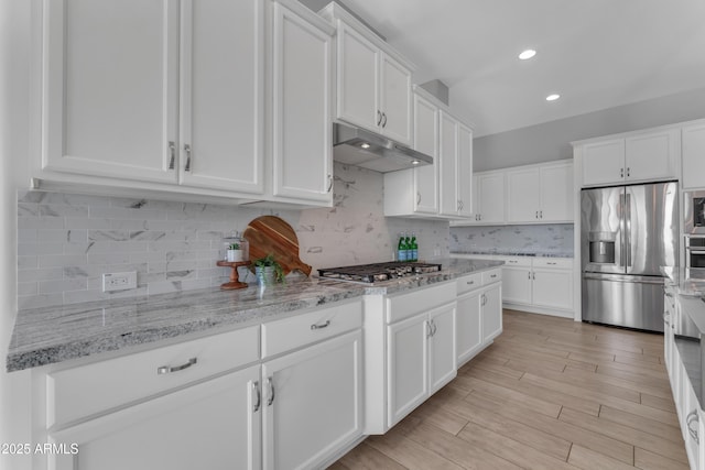 11934 S 181st Ave, Goodyear, AZ 85338 - kitchen with decorative backsplash, white cabinetry, under cabinet range hood, and stainless steel appliances