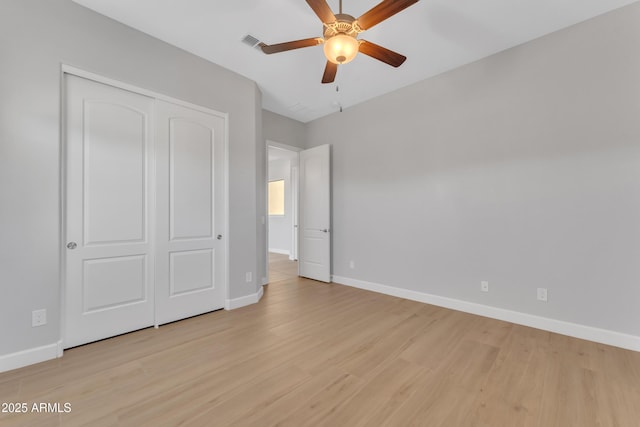11934 S 181st Ave, Goodyear, AZ 85338 - unfurnished bedroom featuring a closet, baseboards, ceiling fan, and light wood-style floors