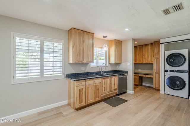 3138 N 82nd Pl, Scottsdale, AZ 85251 - kitchen with light wood-style flooring, visible vents, a sink, stacked washer / dryer, and stainless steel dishwasher