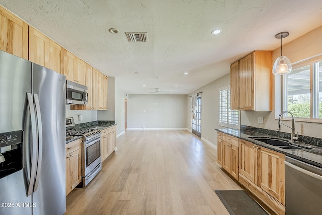 3138 N 82nd Pl, Scottsdale, AZ 85251 - kitchen with light wood-type flooring, plenty of natural light, visible vents, stainless steel appliances, and a sink