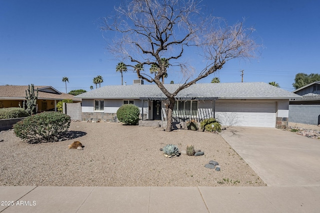 3138 N 82nd Pl, Scottsdale, AZ 85251 - ranch-style home featuring concrete driveway, stone siding, and an attached garage