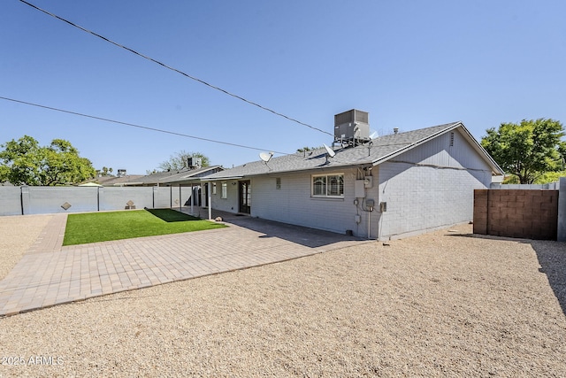 3138 N 82nd Pl, Scottsdale, AZ 85251 - rear view of property featuring a patio, brick siding, a fenced backyard, central AC, and a lawn