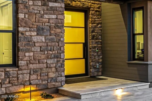 entrance to property with stone siding