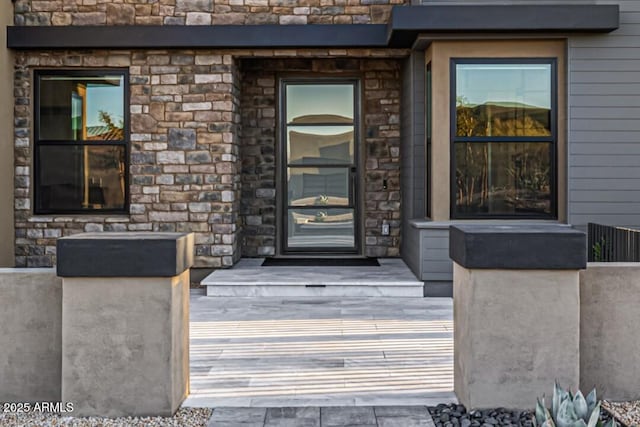 property entrance with stone siding