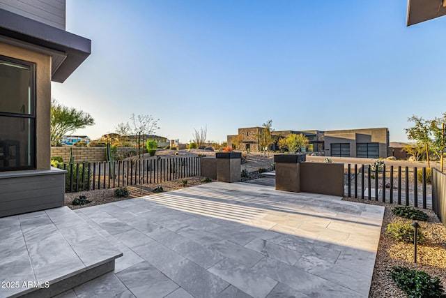 view of patio / terrace featuring fence and a residential view