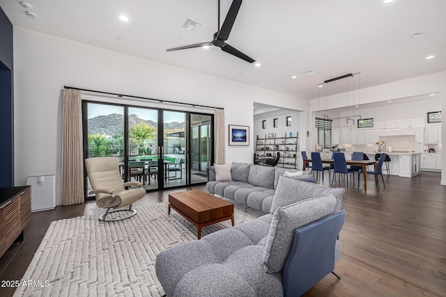 living area with recessed lighting, dark wood-style flooring, and visible vents