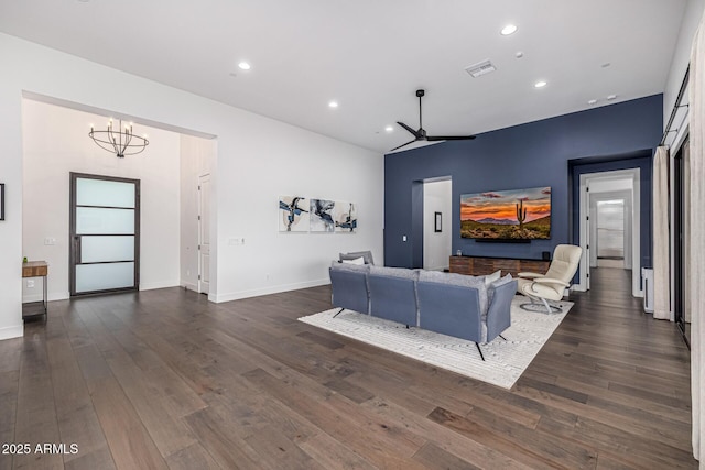 living area featuring baseboards, dark wood-style flooring, visible vents, and recessed lighting