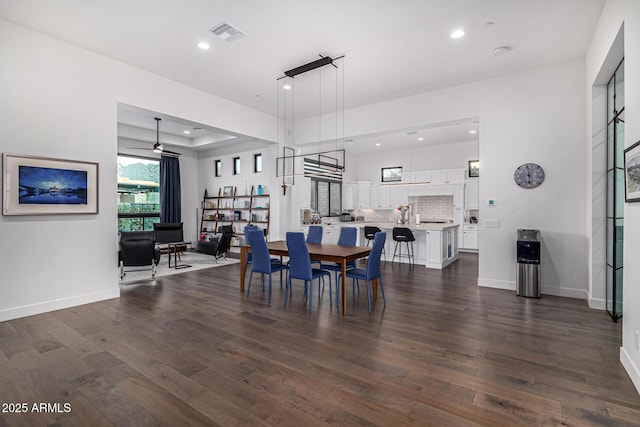 dining room with dark wood-type flooring, recessed lighting, visible vents, and baseboards