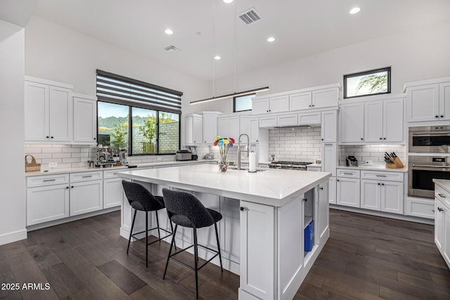 kitchen with white cabinetry and a sink