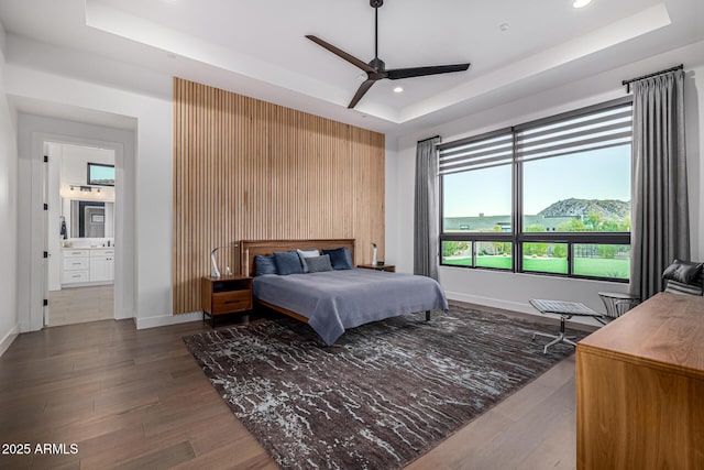 bedroom with recessed lighting, wood finished floors, a ceiling fan, baseboards, and a raised ceiling