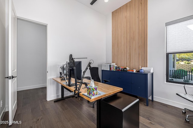 office area with ceiling fan, dark wood finished floors, and baseboards