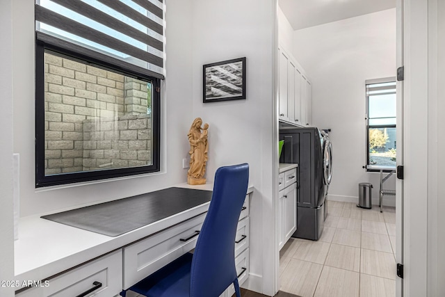 home office with light tile patterned floors, built in study area, and washing machine and clothes dryer