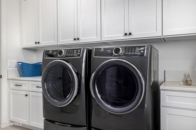 laundry area featuring cabinet space and separate washer and dryer