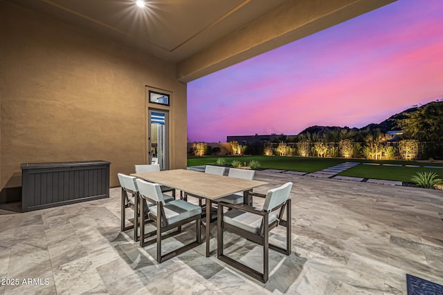 patio terrace at dusk with outdoor dining area