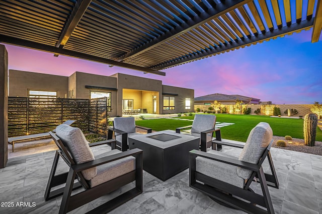 patio terrace at dusk with a fire pit, a lawn, and a pergola