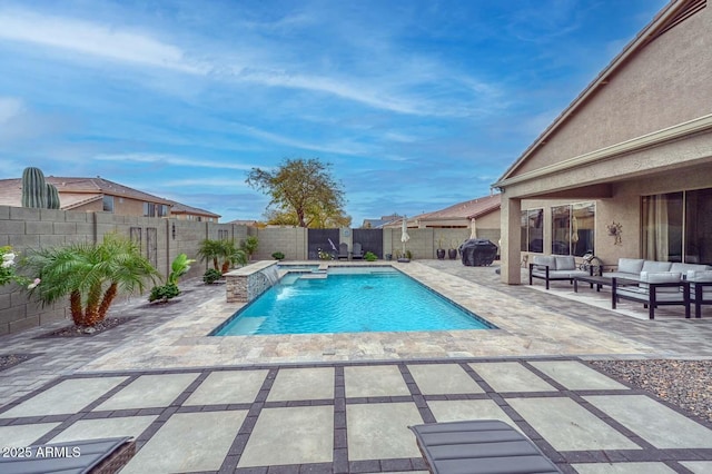 view of swimming pool with pool water feature, outdoor lounge area, and a patio area