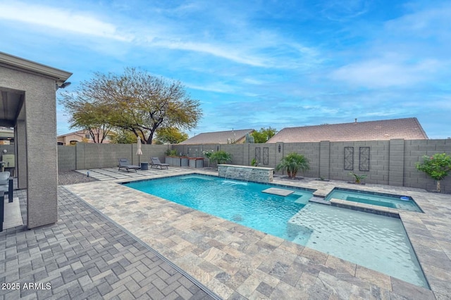 view of pool with an in ground hot tub, pool water feature, and a patio