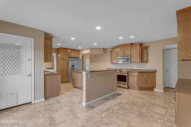 kitchen with appliances with stainless steel finishes and a kitchen island