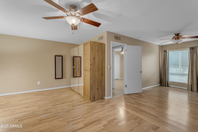 spare room featuring light wood-type flooring and ceiling fan