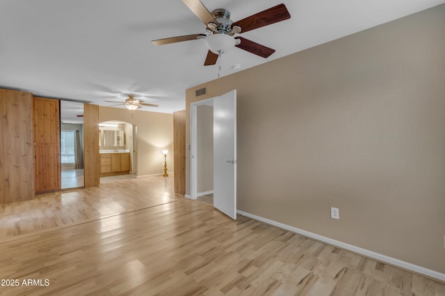 empty room with light wood-type flooring and ceiling fan